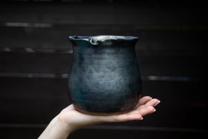 Porcelain vase with one-of-a-kind hand detail at the rim. Gunmetal black glaze.